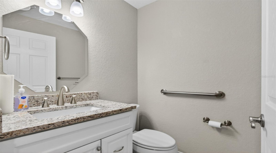 Guest Bathroom: Well-appointed guest bath with modern fixtures and neutral finishes.
