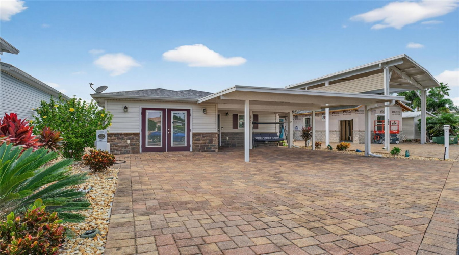 Front Exterior: Spacious carport with easy access to entryway, practical and low-maintenance.