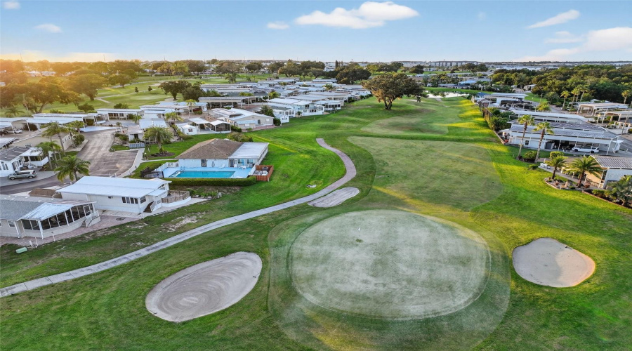 Aerial angle reveals proximity to golf course, clubhouse, and community amenities.