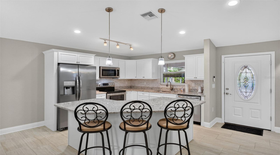 Kitchen: Granite counter-tops, stainless steel appliances, and plenty of cabinet space.