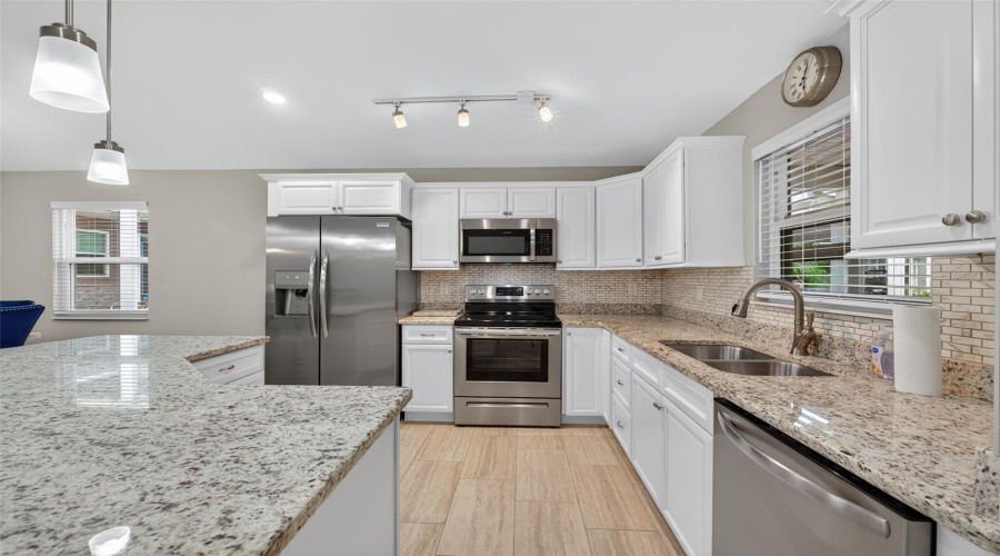 Kitchen: Stylish kitchen featuring granite counter-tops, stainless steel appliances, and modern cabinetry.