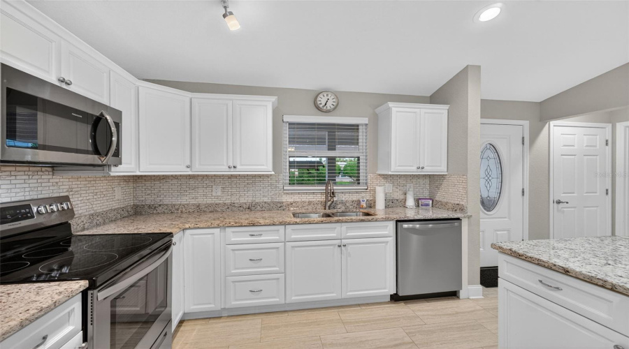 Kitchen: Granite counter-tops, stainless steel appliances, and plenty of cabinet space.