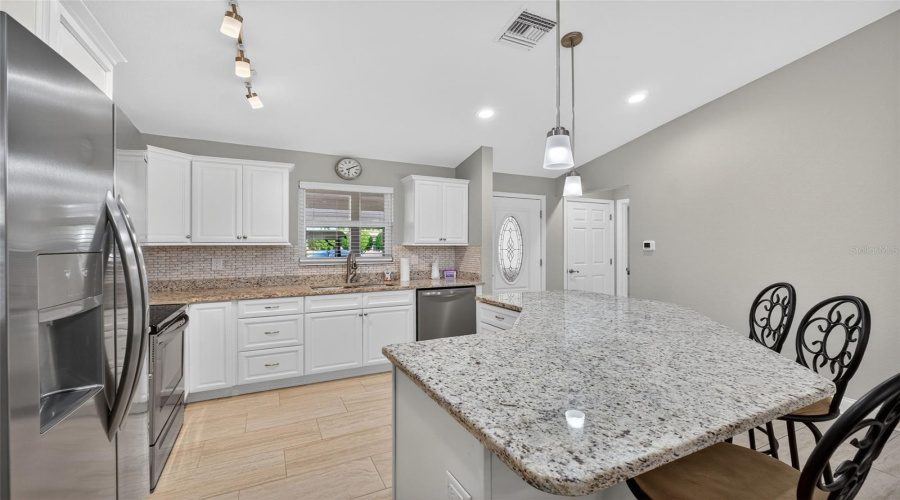 Kitchen: Stylish kitchen featuring granite counter-tops, stainless steel appliances, and modern cabinetry.