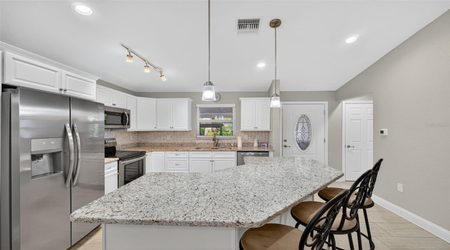 Kitchen: Granite counter-tops, stainless steel appliances, and plenty of cabinet space.