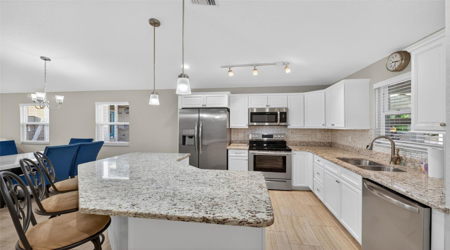 Kitchen: Stylish kitchen featuring granite counter-tops, stainless steel appliances, and modern cabinetry.