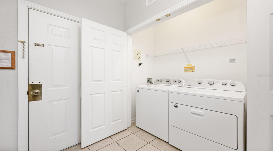 A functional Laundry closet includes shelving for storing supplies.