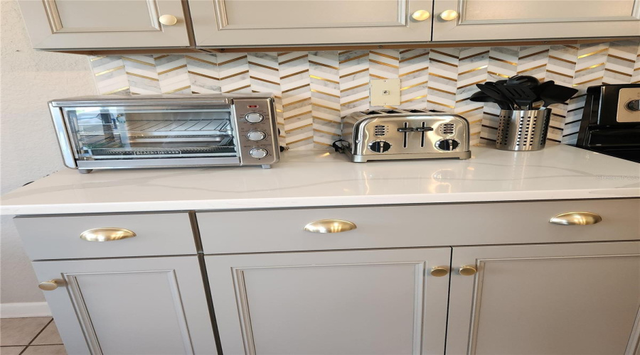 Granite countertops and tile backsplash