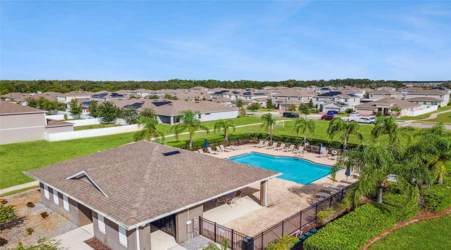 Community pool with home in the photo