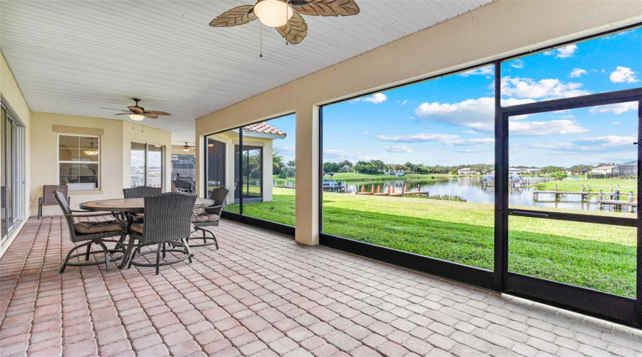 The screened brick paver lanai is your perfect oasis to escape to after a long day and enjoy your favorite libation.