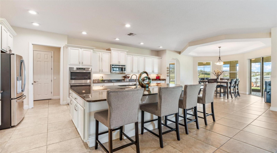 Your gourmet kitchen is a chef's dream come true and is well equipped with upgraded stainless steel appliances and double ovens.