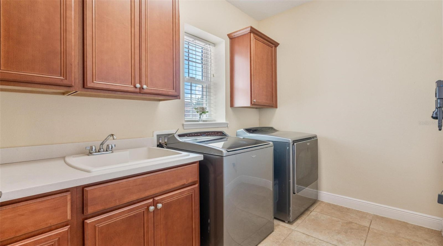 The 1st floor laundry room offers you ample counter space and storage cabinets.