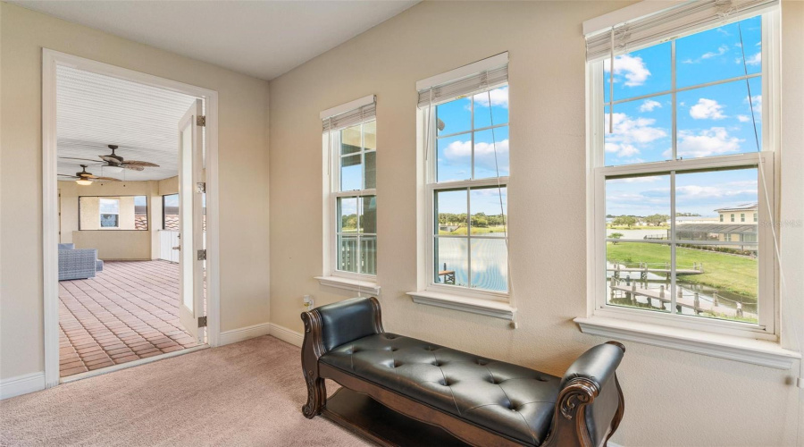Master retreat sitting area with breathtaking water views and access to the 2nd floor balcony.