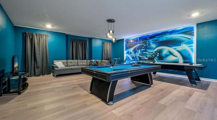 Recreation Room: Oversized entertainment/game room (24’ × 23’), designed for  games, and quality time together.