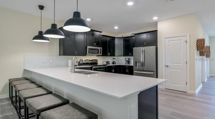 Kitchen: Open concept with central island, connected to the Family Room and Dining Room
