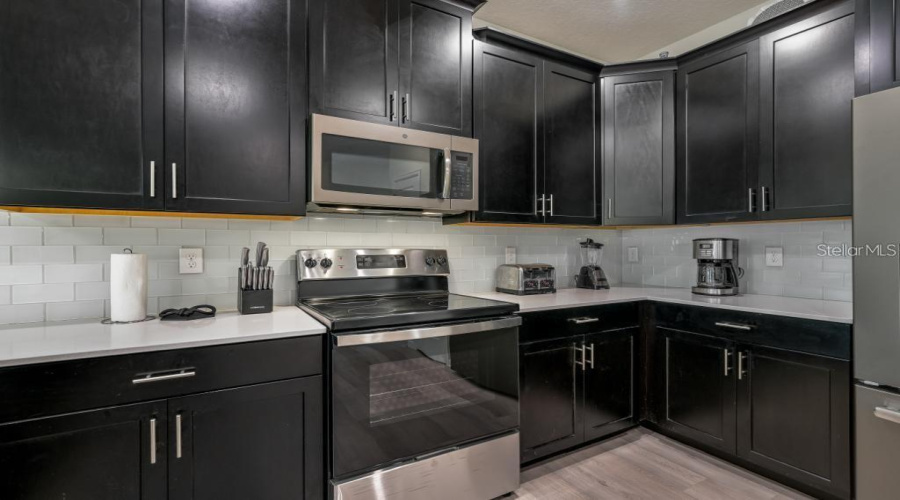 Kitchen: Open concept with central island, connected to the Family Room and Dining Room