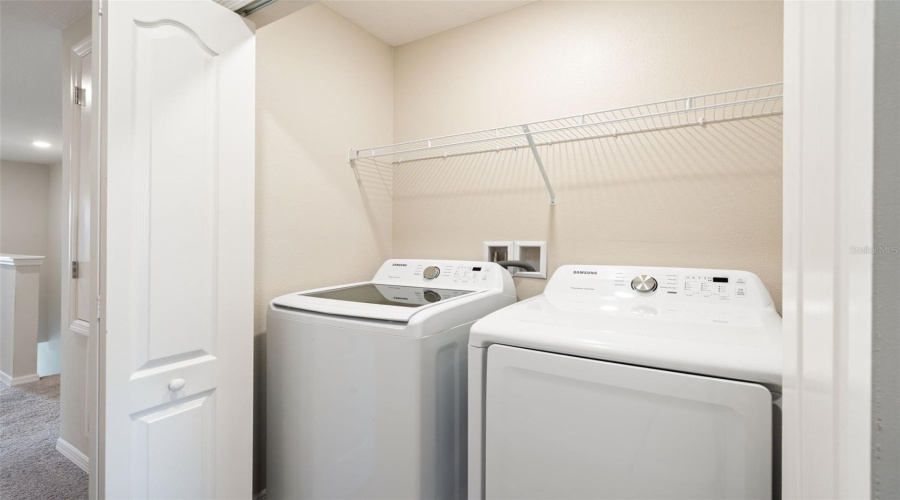 Interior laundry closet. Washer and dryer convey