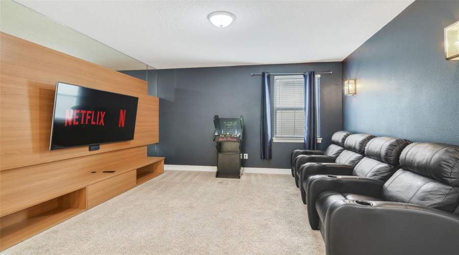A bonus theater room upstairs provides the perfect spot for movie nights or entertaining guests.