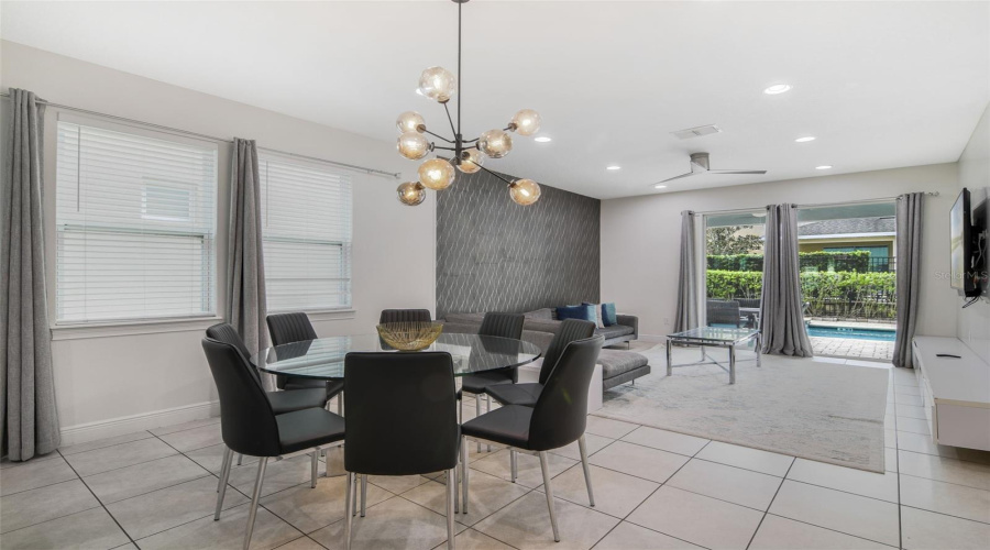 Step inside to a bright and spacious OPEN-CONCEPT design where the Kitchen, Dining, and Living areas flow seamlessly together, all overlooking the HEATED FRESHWATER POOL, SPA and private patio.