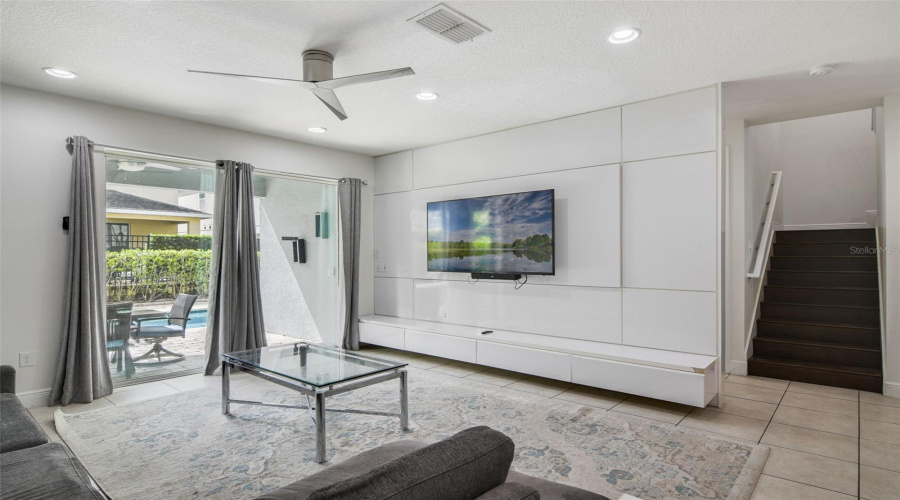 The Living Room showcases a contemporary accent wall complete with built-in storage, perfect for keeping the space organized while adding a designer touch.