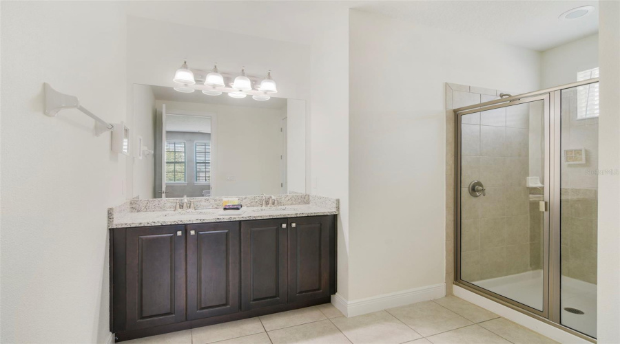 The Primary en suite Bath with dual sinks, a step-in shower and a private water closet.