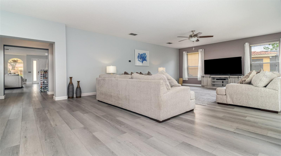 Living area with magnificient views of pool, lanai and wooded area.