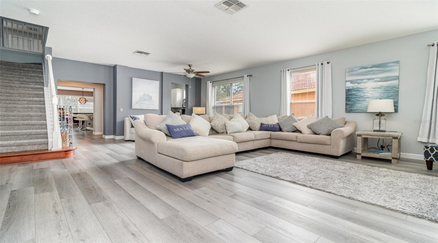 Step through the front door to an expansive living/dining room area with stairway on the left.