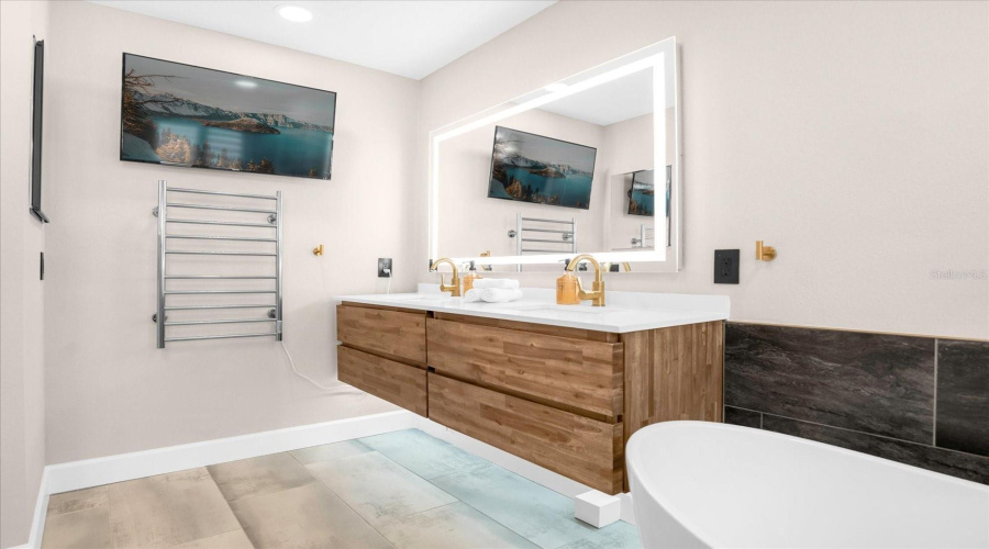 floating vanity with fog free mirrors and electrical towel dryer