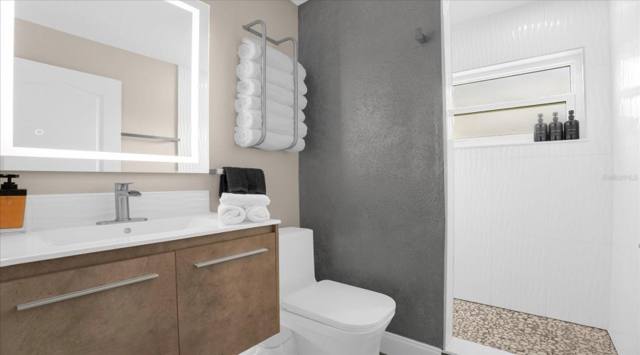 floating vanity, fog free mirror and walk in shower