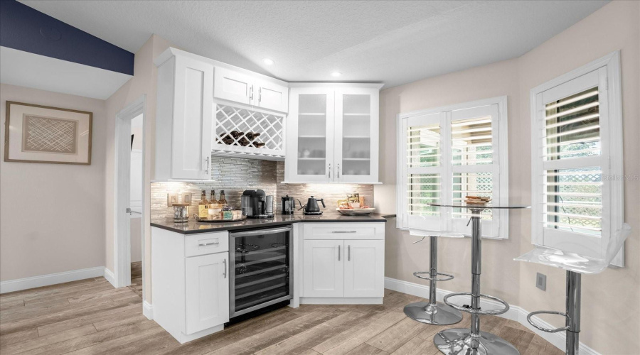 breakfast nook with wine rack and fridge