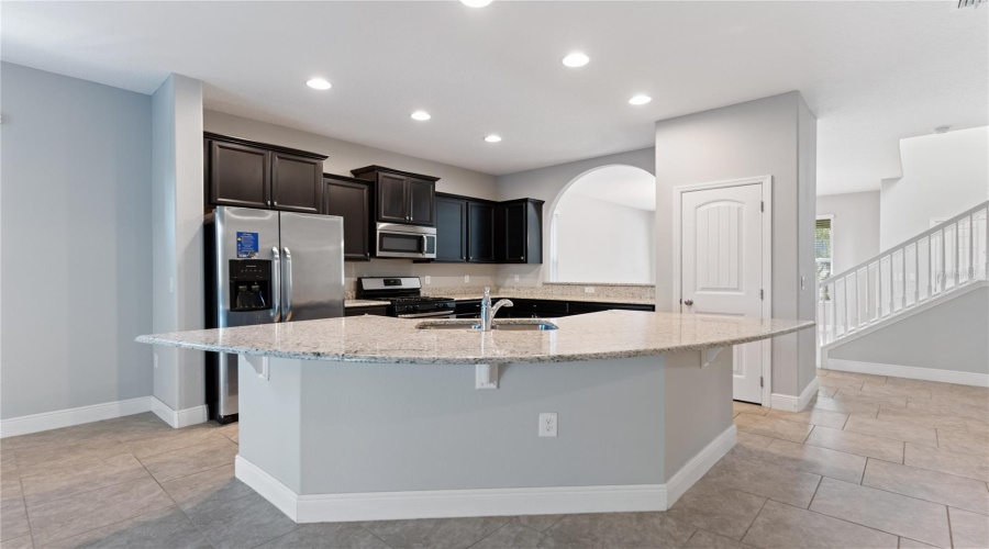 granite counters, stainless steel appliances, and pantry