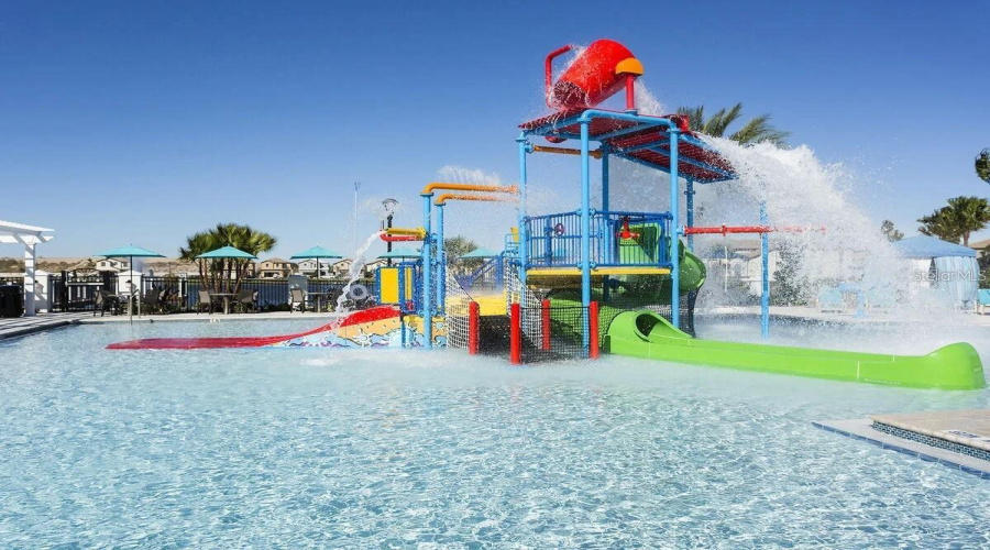 An interactive splash park with a water slide An interactive splash park with a water slide