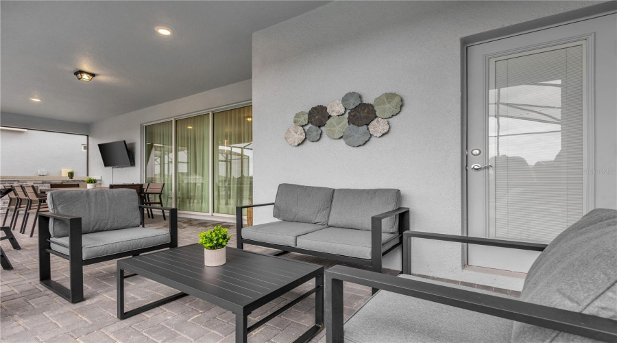 Outdoor - Covered patio with dining table, summer kitchen and conversation set