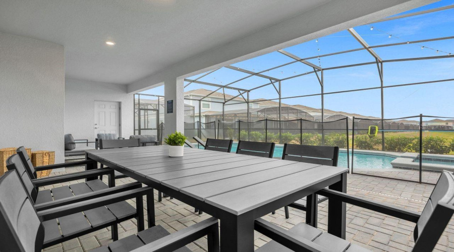 Outdoor - Covered patio with dining table, summer kitchen and conversation set