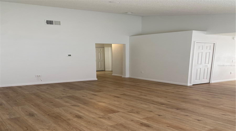 Living room with hallway entrance to garage and additional bedrooms