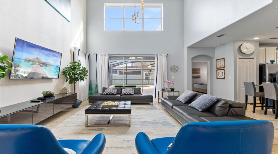 Living area with TV and high ceiling.