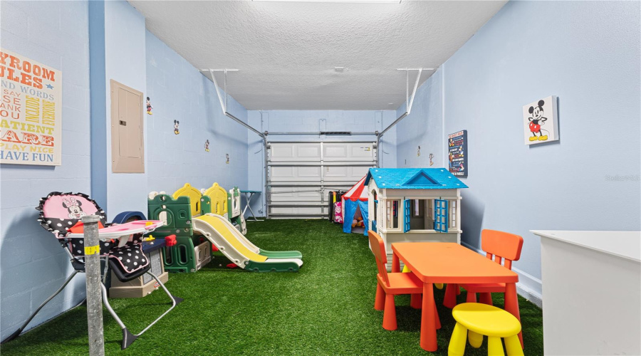Converted garage with artificial grass, toys, games and ac.
