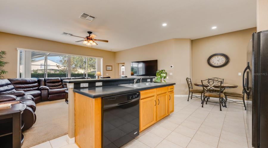 The Kitchen offers a BREAKFAST BAR, EAT-IN NOOK, WALK-IN PANTRY, MODERN BLACK APPLIANCES, and easy flow into the cozy Family Room.