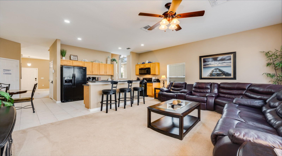 The Kitchen offers a BREAKFAST BAR, EAT-IN NOOK, WALK-IN PANTRY, MODERN BLACK APPLIANCES, and easy flow into the cozy Family Room.