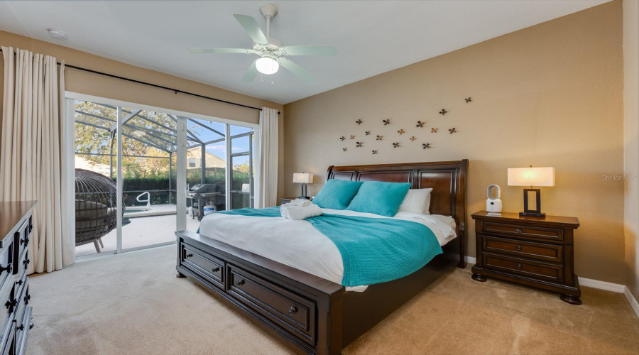 The Primary Suite on the main floor is a serene retreat featuring sliding doors that provide direct ACCESS TO THE POOL—perfect for an early morning dip.