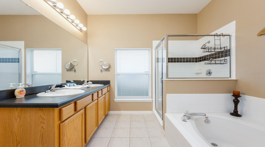 The Primary EN SUITE BATH with dual sinks, garden tub, step-in shower, and private water closet is the perfect place to relax and recharge at the end of a long day.