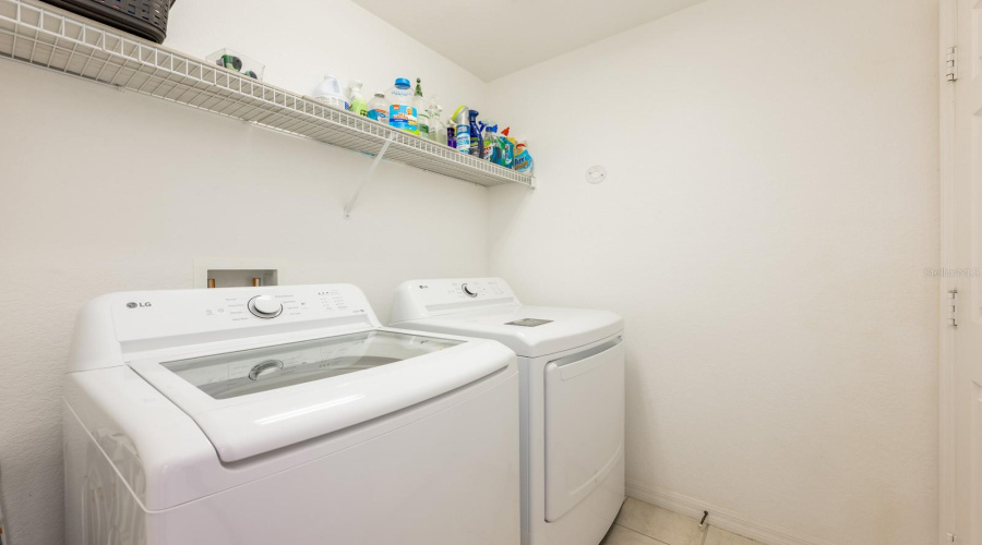 A stylish half bath and laundry room on the first floor serve guests and pool users with ease.