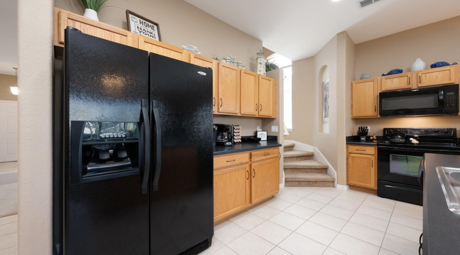 Continue down the hall to the inviting Kitchen and Family Room, an OPEN-CONCEPT space designed for gathering.