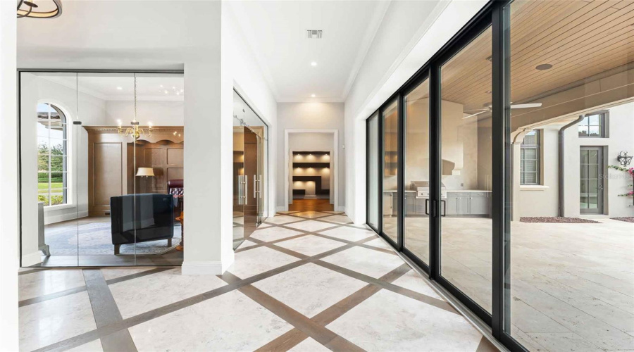 Accordion sliders hallway leads to the primary wing and two additional ensuite bedrooms..