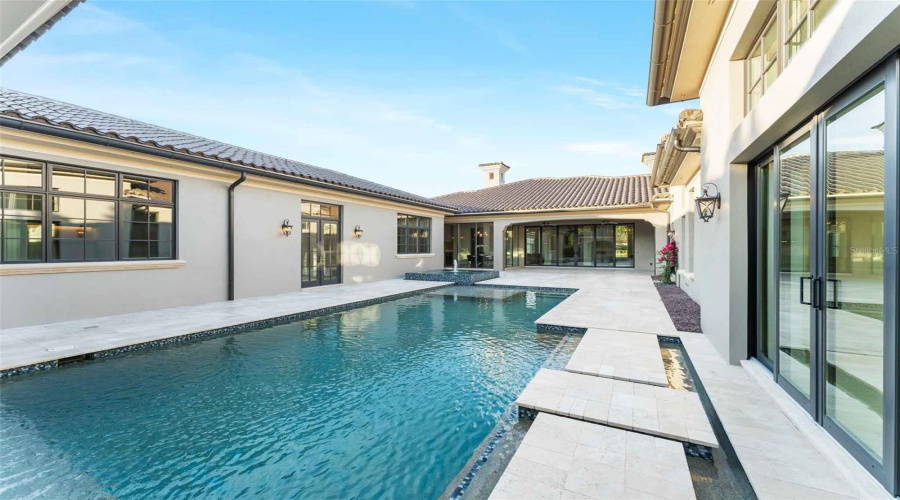 Beautiful courtyard pool features gorgeous structure, character and privacy in its design..
