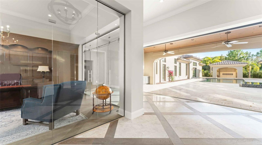 One step inside and you are greeted with disappearing accordion sliders and a stunning glass-walled office..