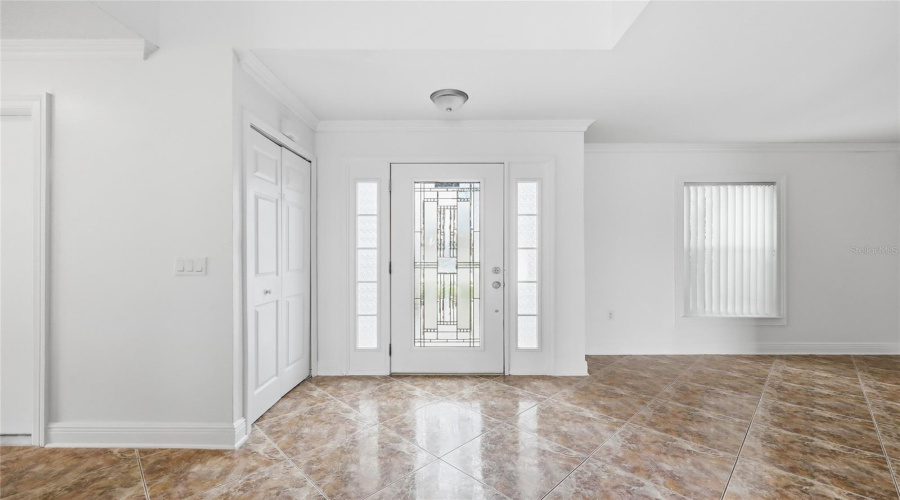 Entrance- Downstairs guest room to the left/ former living to the right