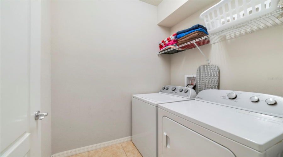 A convenient half bath and a separate laundry room are also located on the main level.