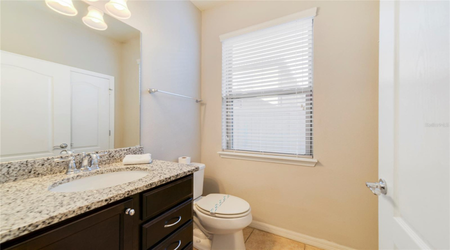 A convenient half bath and a separate laundry room are also located on the main level.