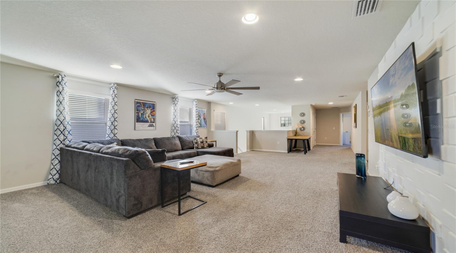 Upstairs, a SPACIOUS LOFT provides an additional lounge or TV area—perfect for guests.