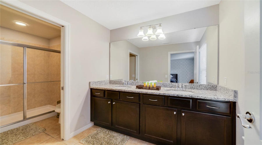 Bedroom 6 has its own en suite Bath completed by a modern vanity with dual sinks and a step-in shower—ideal for comfort and convenience.